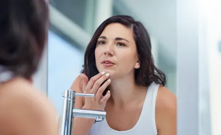 Bioderma - Woman checking in the mirror